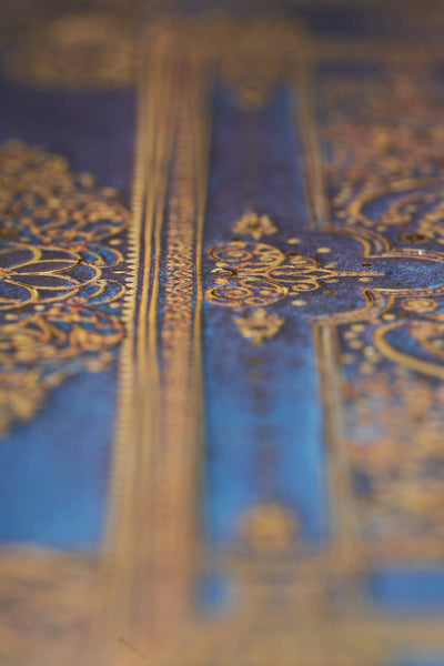 Close-up of a blue fabric with gold embroidery
