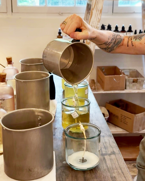 Guest creating a custom soy candle at the Bode+Ev Candle Studio inside Two Funky Hippies in Roswell, Georgia.