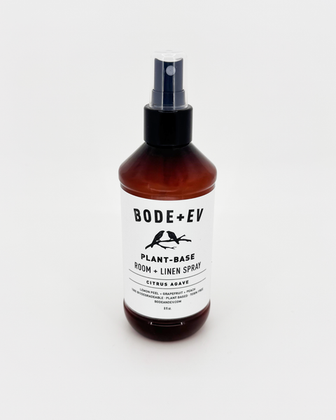 Plant-based room and linen spray bottle styled in a clean, modern home setting